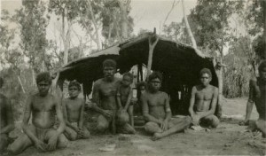 Aboriginal_boys_and_men_in_front_of_a_bush_shelter_-_NTL_PH0731-0022